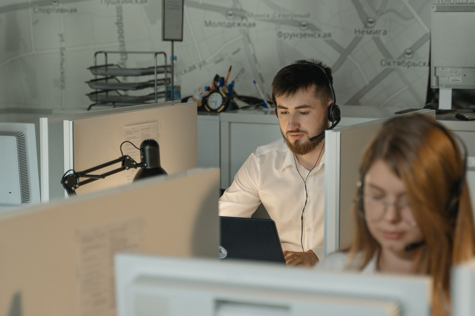 Collections agents working with headsets in an office
