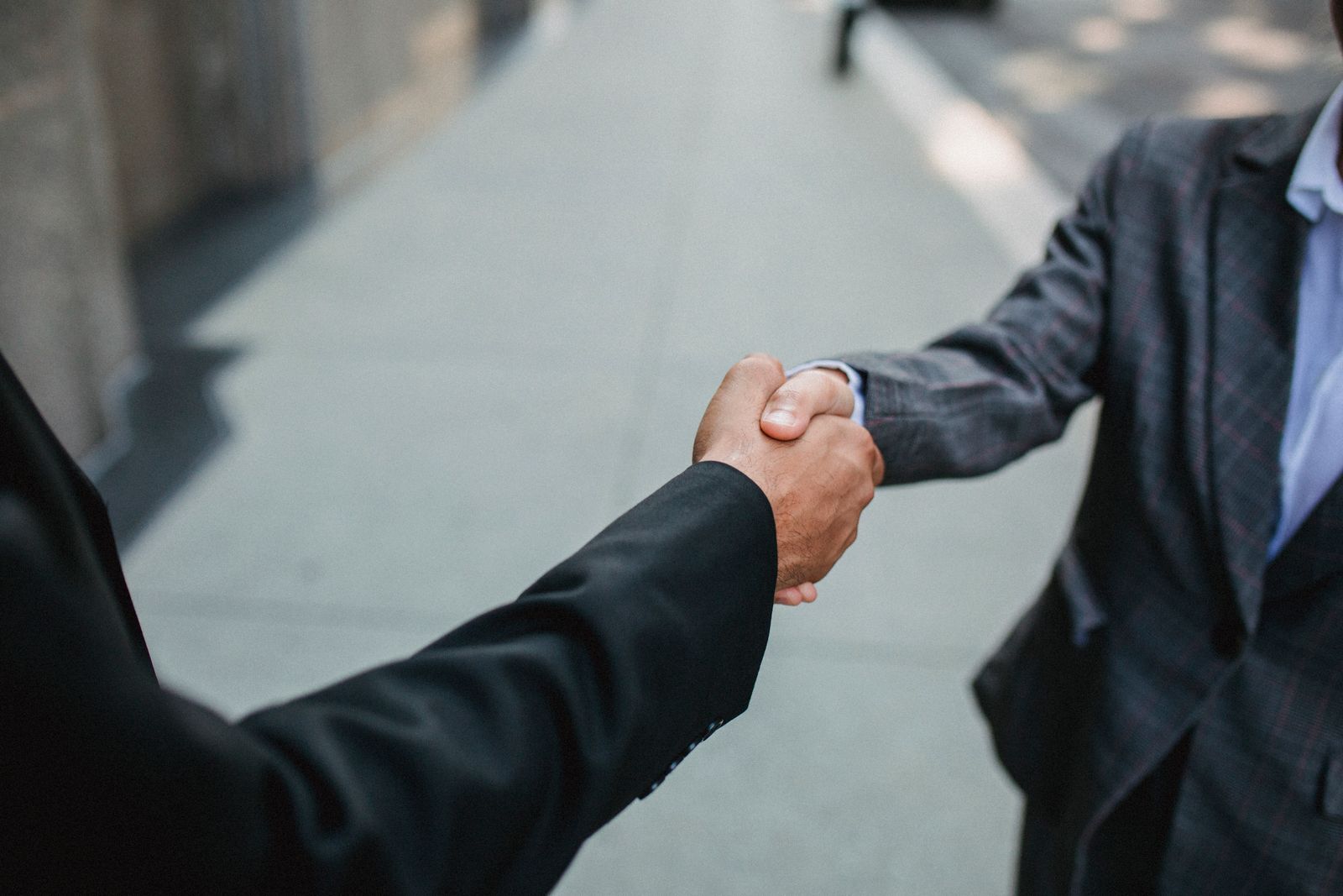 Two professionals shaking hands on an agreement