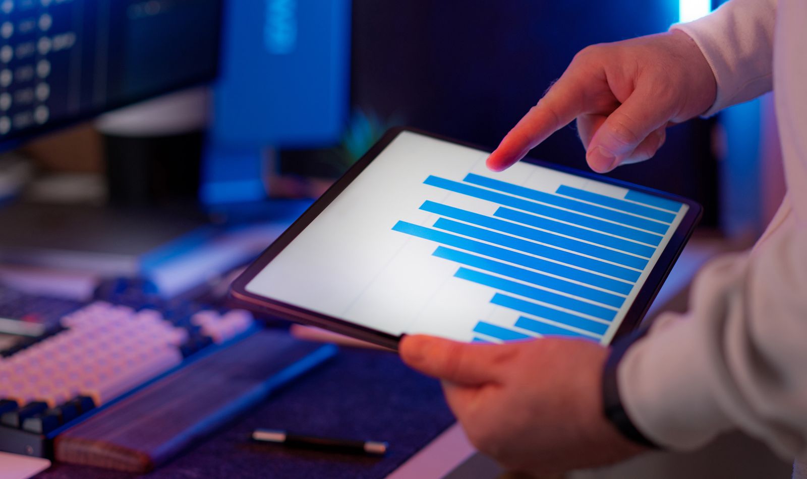 Reviewing a rising financial performance chart on a tablet